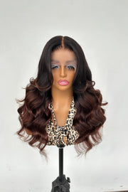 Mannequin head with a brown wig on a white background