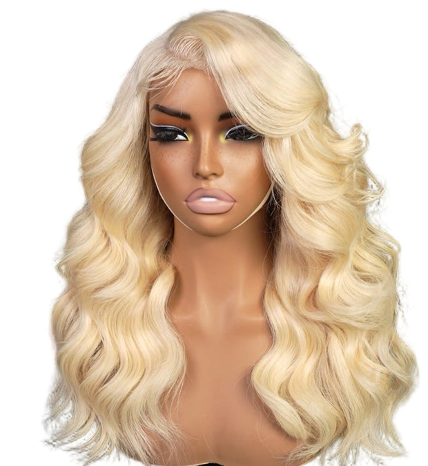 Blonde wig on a mannequin head against a white background